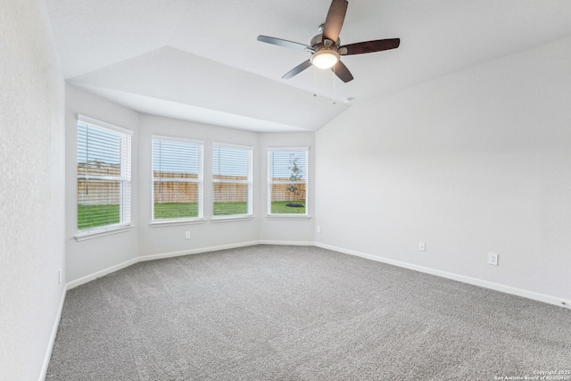 carpeted empty room with ceiling fan and vaulted ceiling