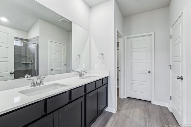 bathroom featuring vanity and a shower with shower door