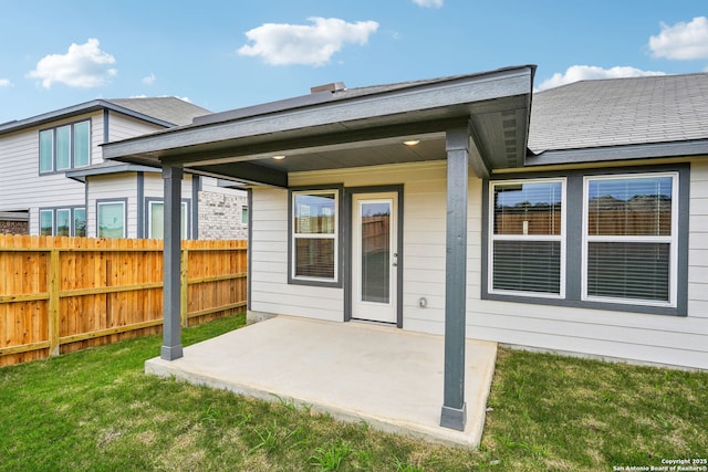 rear view of house featuring a lawn and a patio