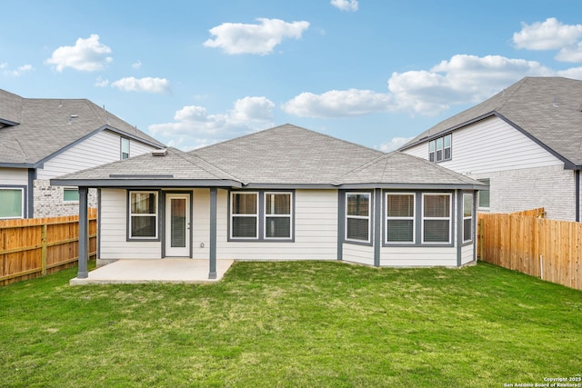 rear view of property featuring a lawn and a patio area