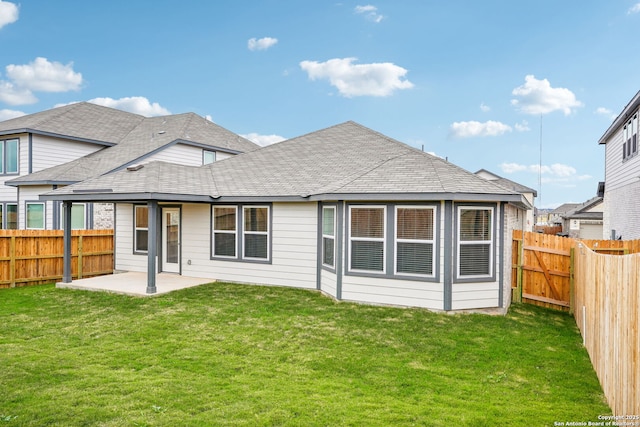 back of house with a patio and a yard