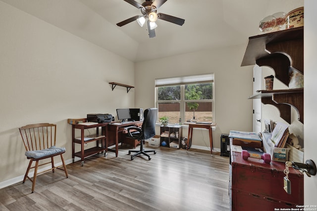 office featuring ceiling fan, light wood-type flooring, and vaulted ceiling