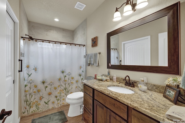 bathroom with toilet, a shower with curtain, and vanity