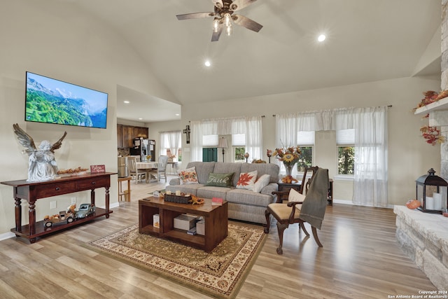 living room with high vaulted ceiling, light hardwood / wood-style floors, and ceiling fan