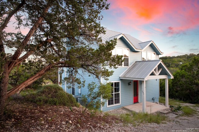 282 Hill Top, Lakehills, TX 78063 - view of front of home with metal roof and a patio area