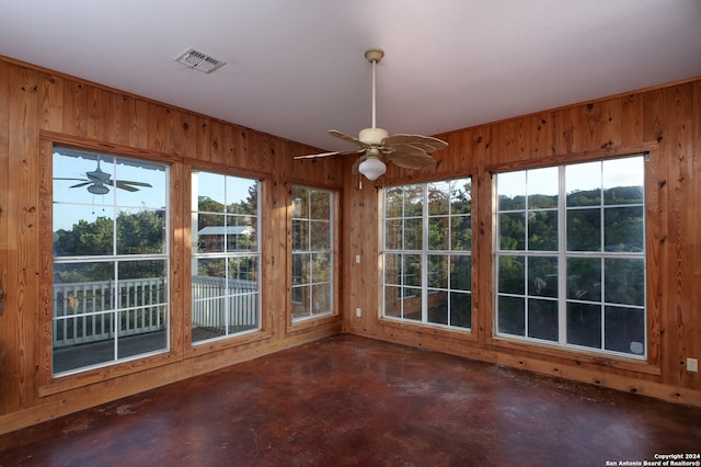 unfurnished sunroom featuring ceiling fan