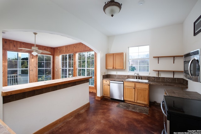 kitchen with ceiling fan, sink, appliances with stainless steel finishes, and plenty of natural light