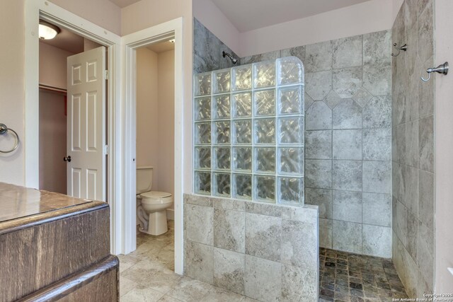 282 Hill Top, Lakehills, TX 78063 - kitchen with appliances with stainless steel finishes, a ceiling fan, concrete floors, wood walls, and a fireplace with raised hearth