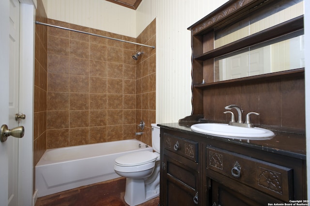 full bathroom featuring toilet, tiled shower / bath combo, and vanity