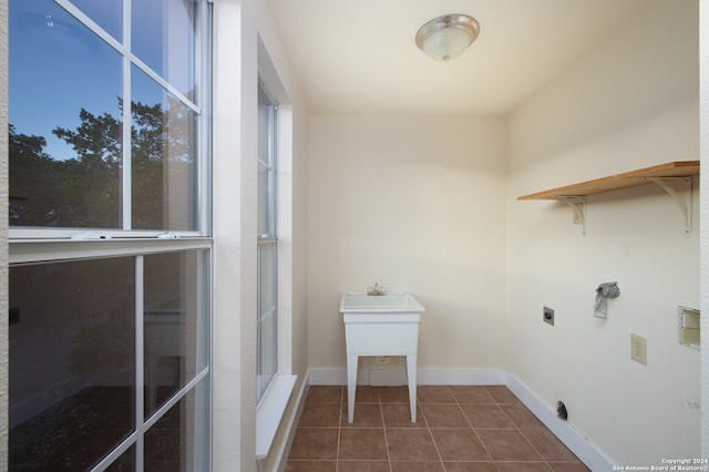 laundry room with dark tile patterned floors and electric dryer hookup