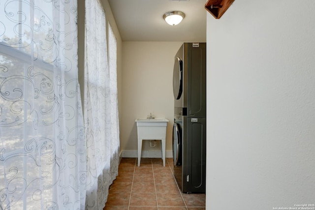 282 Hill Top, Lakehills, TX 78063 - laundry area featuring stacked washer / dryer and light tile patterned floors