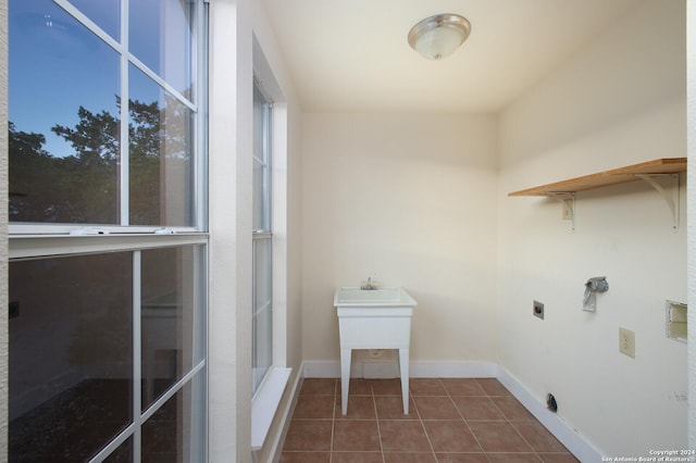 282 Hill Top, Lakehills, TX 78063 - laundry area featuring electric dryer hookup, dark tile patterned flooring, and baseboards
