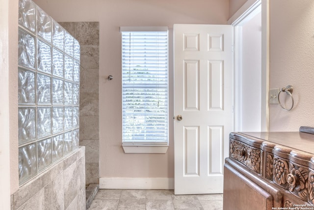 282 Hill Top, Lakehills, TX 78063 - bathroom with healthy amount of natural light, baseboards, walk in shower, and tile patterned flooring