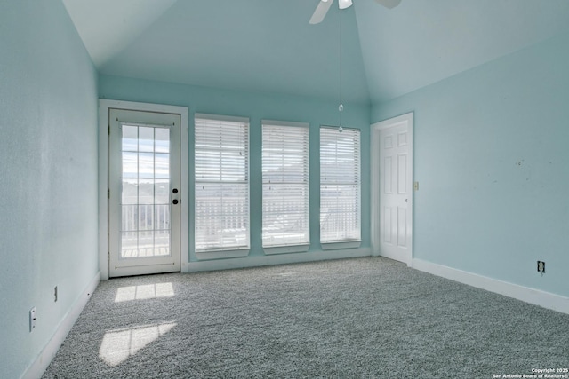 spare room with ceiling fan, light carpet, and lofted ceiling