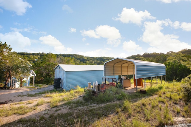 view of outbuilding with a carport