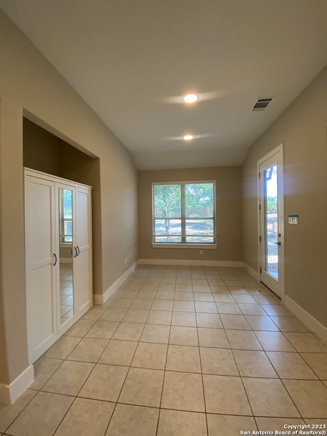 spare room featuring light tile patterned flooring