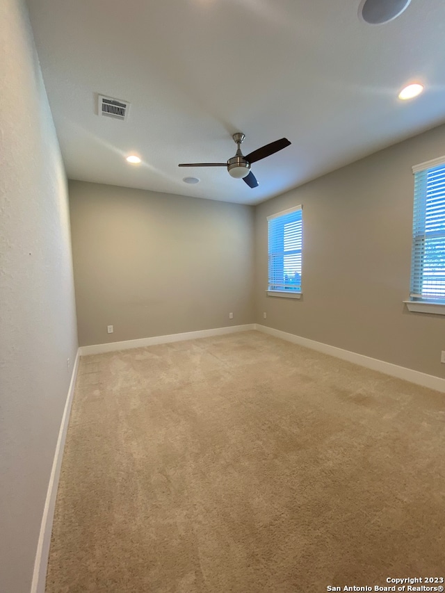 carpeted empty room with ceiling fan