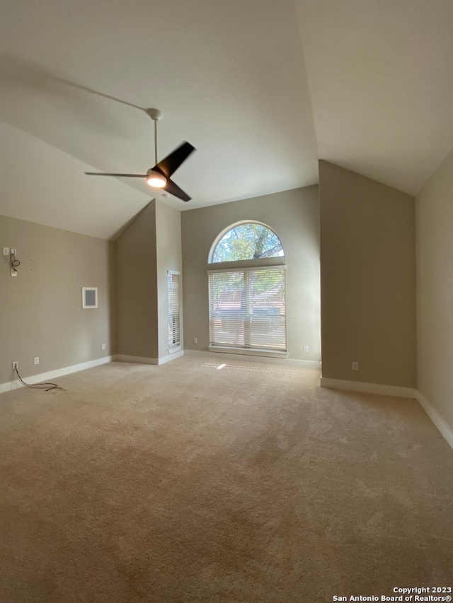 unfurnished living room with carpet floors, ceiling fan, and vaulted ceiling