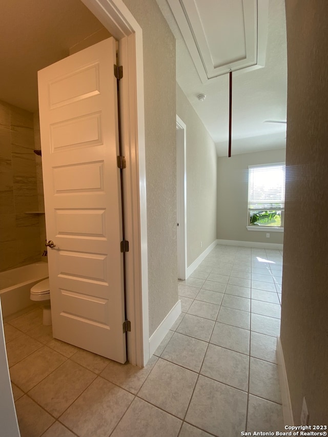 hall featuring light tile patterned flooring