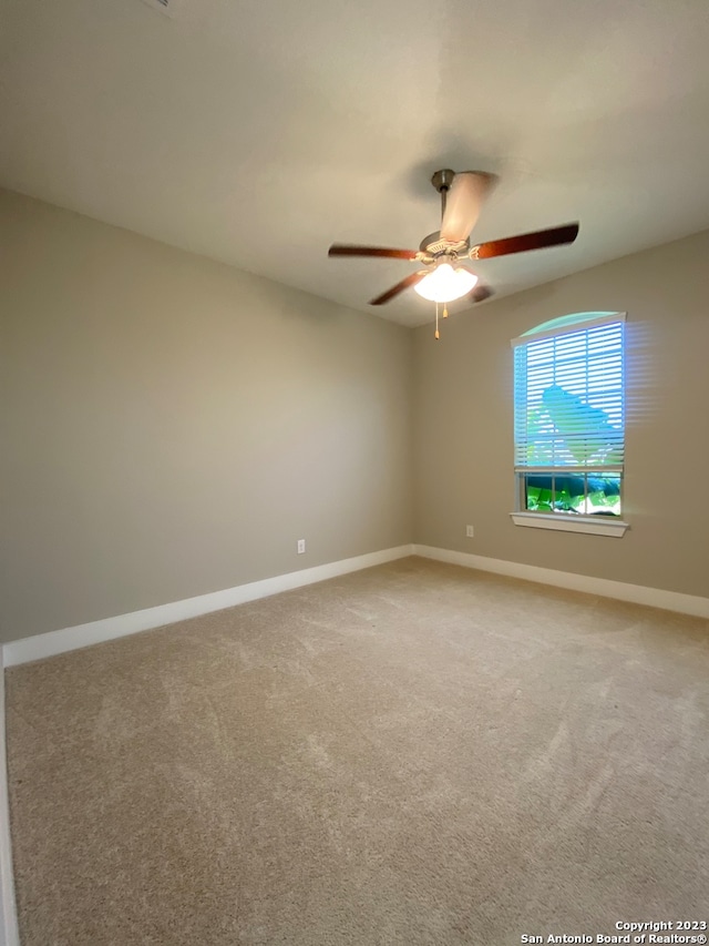 empty room featuring carpet and ceiling fan