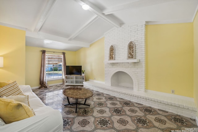 living room featuring vaulted ceiling with beams and a brick fireplace