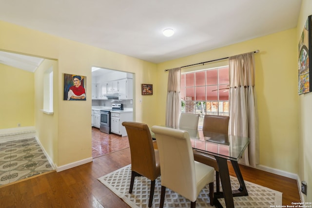 dining space with hardwood / wood-style floors