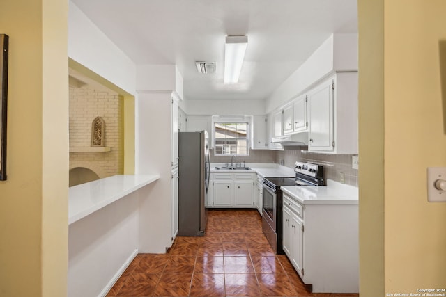 kitchen featuring appliances with stainless steel finishes, sink, dark parquet flooring, white cabinetry, and decorative backsplash