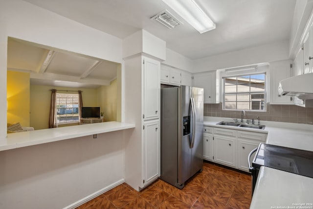 kitchen with tasteful backsplash, sink, white cabinetry, stainless steel fridge with ice dispenser, and ventilation hood