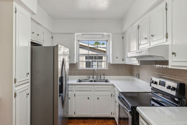 kitchen featuring sink, white cabinets, stainless steel appliances, and backsplash