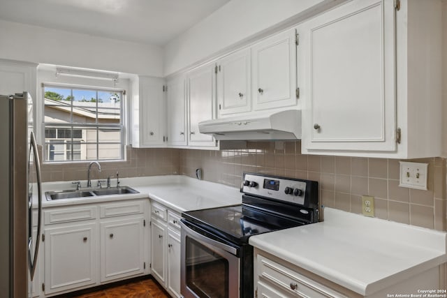 kitchen featuring tasteful backsplash, appliances with stainless steel finishes, sink, and white cabinets