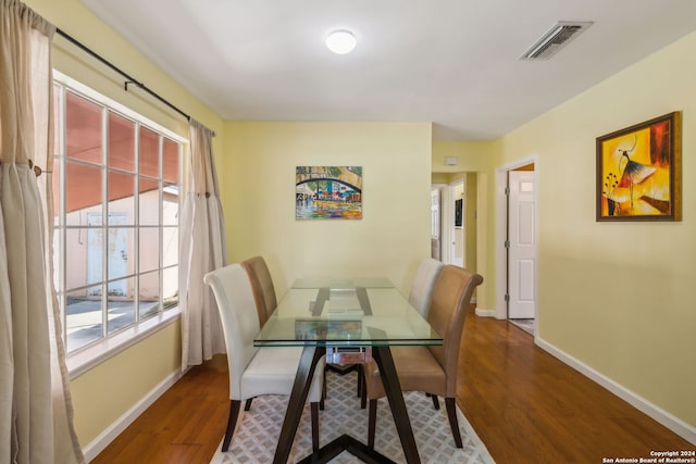 dining space with dark hardwood / wood-style flooring