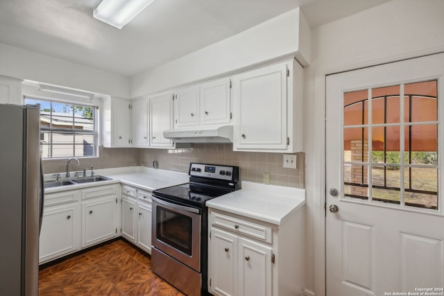 kitchen featuring white cabinetry, backsplash, appliances with stainless steel finishes, and sink