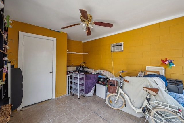 interior space with ceiling fan and a wall unit AC