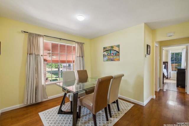 dining area featuring ceiling fan and dark hardwood / wood-style floors