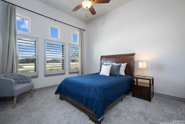 bedroom featuring light carpet, lofted ceiling, and ceiling fan