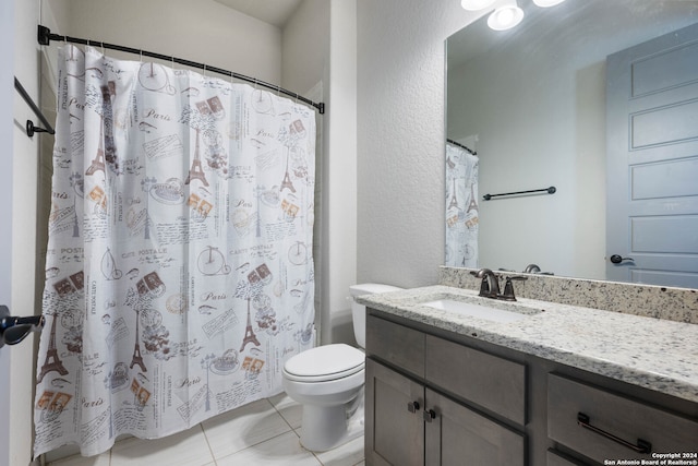 bathroom featuring vanity, toilet, tile patterned floors, and a shower with curtain