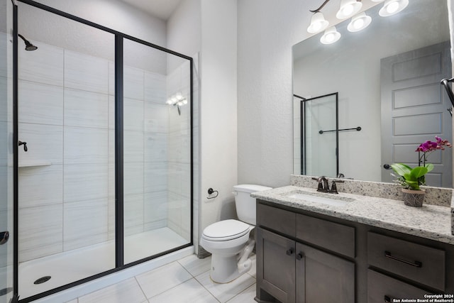 bathroom featuring vanity, toilet, walk in shower, and tile patterned flooring