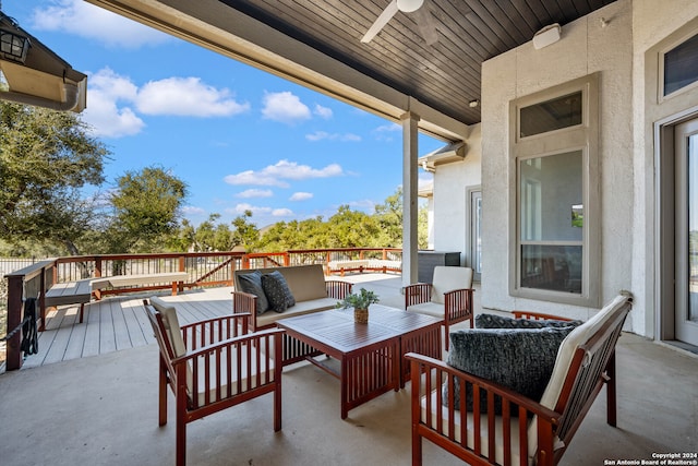 view of patio featuring a wooden deck, ceiling fan, and an outdoor hangout area