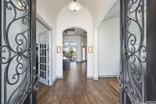 foyer entrance featuring lofted ceiling and dark hardwood / wood-style flooring