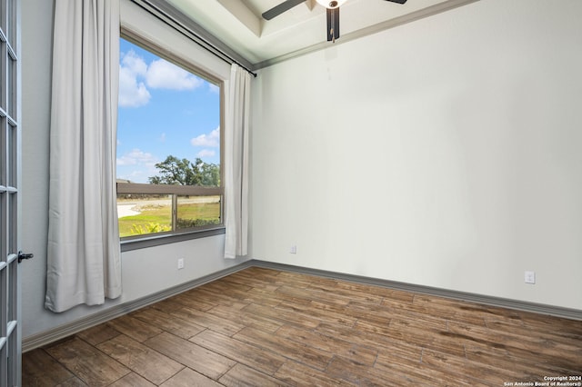 unfurnished room with wood-type flooring, plenty of natural light, and ceiling fan