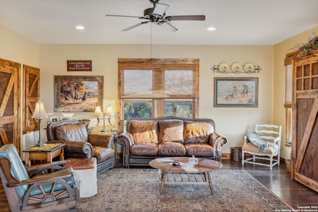 living room with ceiling fan and dark hardwood / wood-style flooring