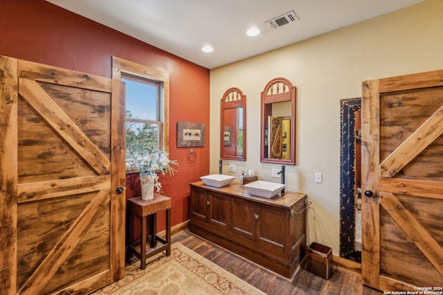 bathroom with vanity and hardwood / wood-style floors