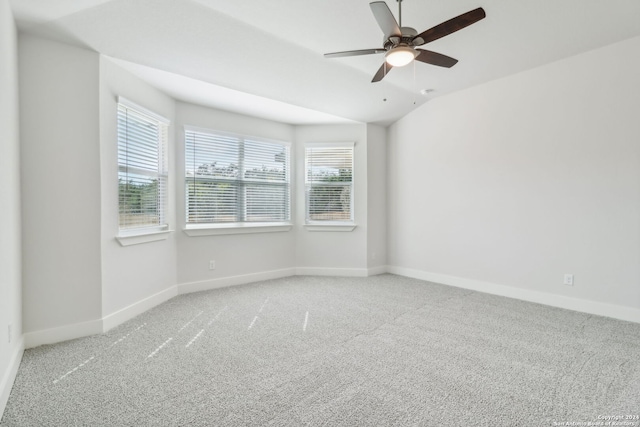 carpeted empty room featuring ceiling fan and lofted ceiling