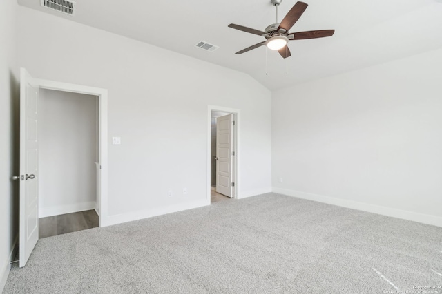 carpeted empty room featuring ceiling fan and lofted ceiling