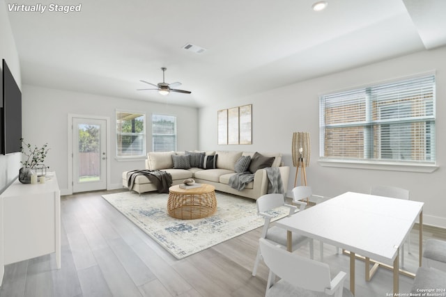 living room featuring ceiling fan and light wood-type flooring