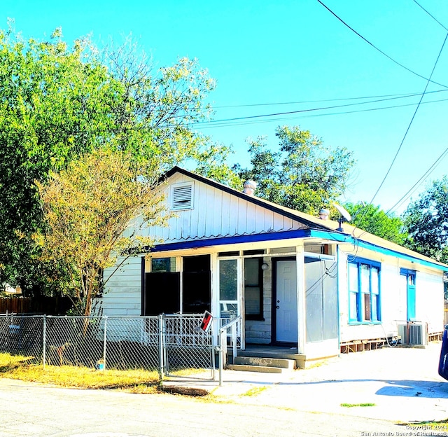 bungalow-style house with cooling unit