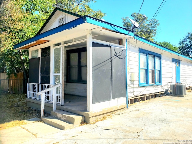 view of side of property featuring central AC