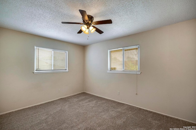 carpeted empty room featuring a textured ceiling and ceiling fan