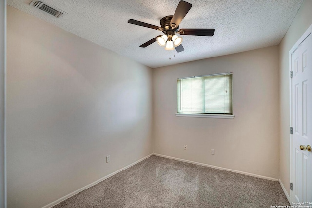 unfurnished room with a textured ceiling, carpet flooring, and ceiling fan