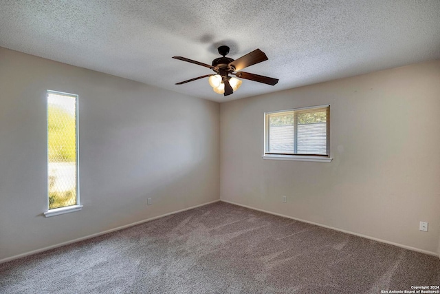 spare room with a healthy amount of sunlight, carpet flooring, and ceiling fan